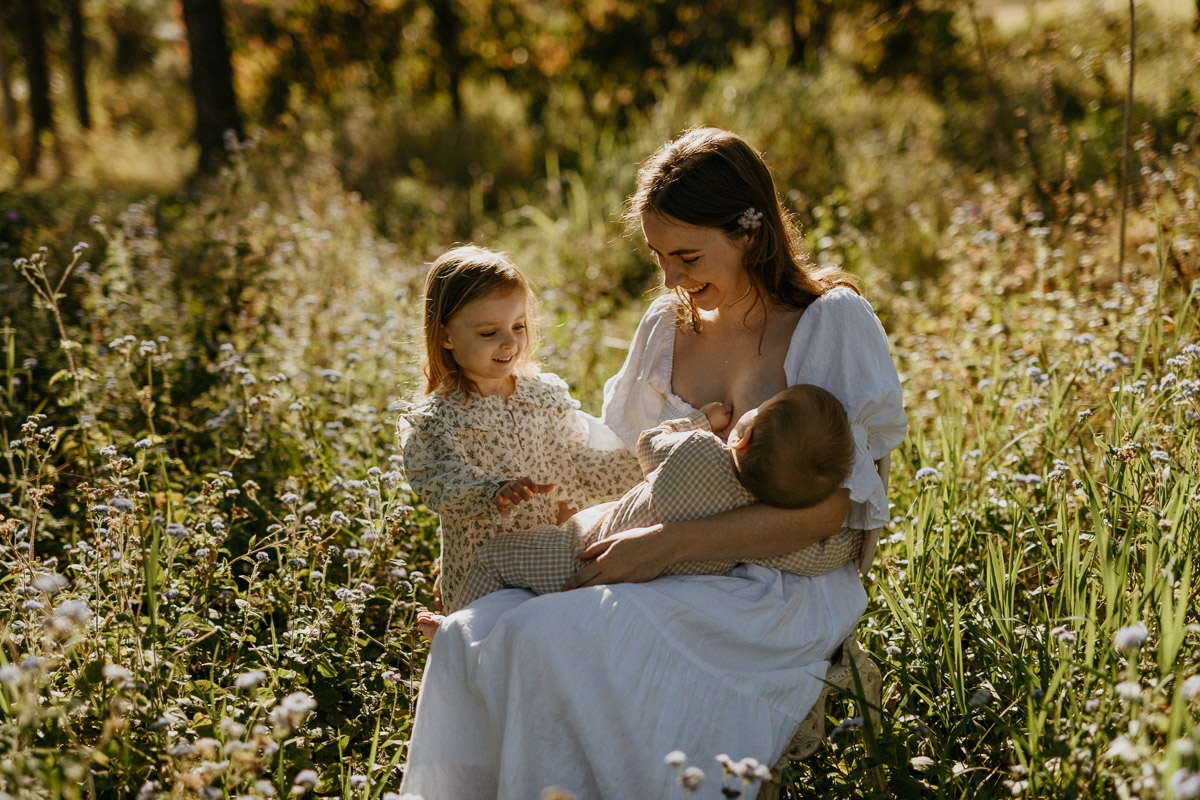 “Candid, soulful family photography focused on connection and motherhood during a wildflower-filled session.”